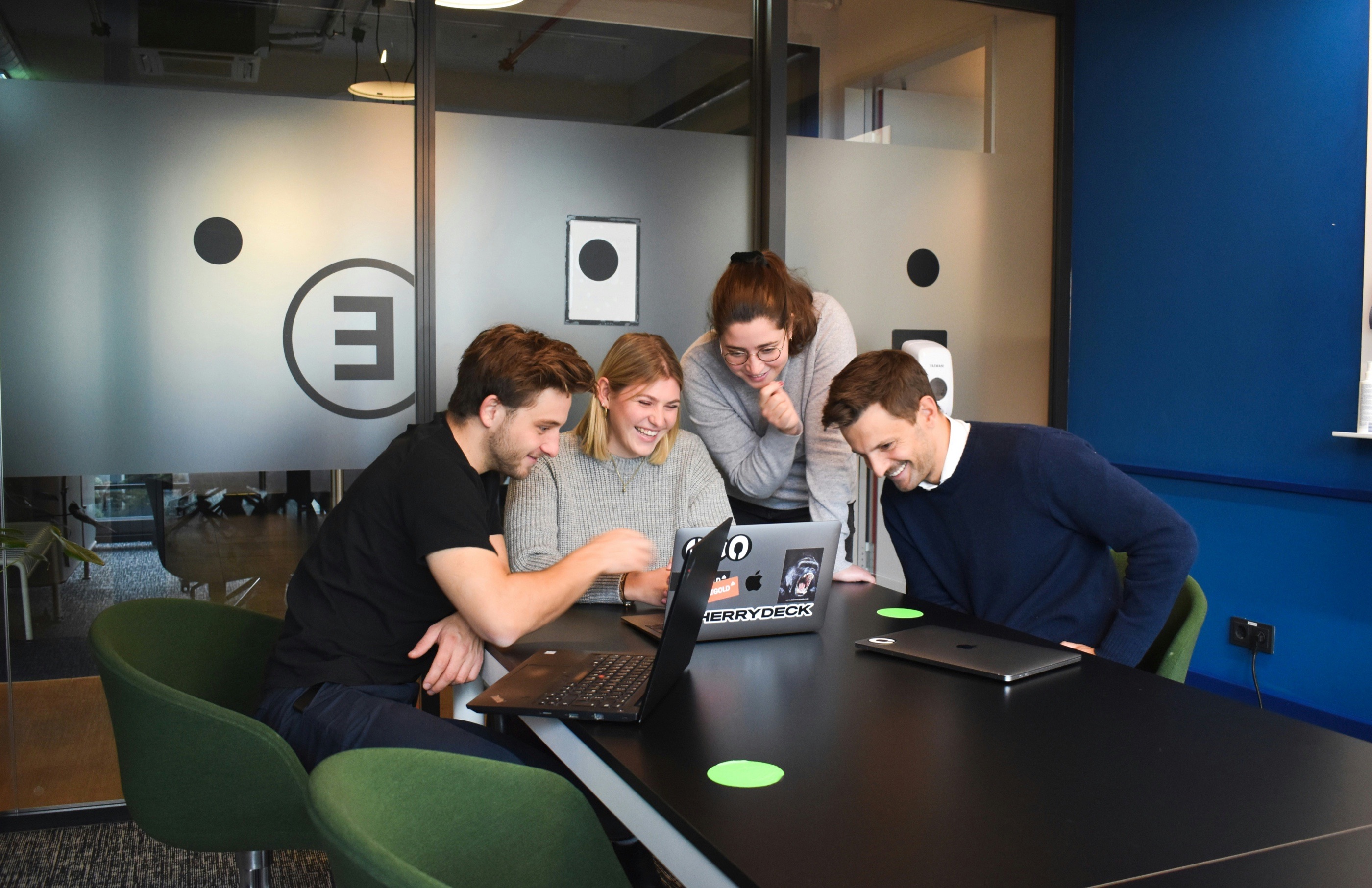 Team working together around a laptop